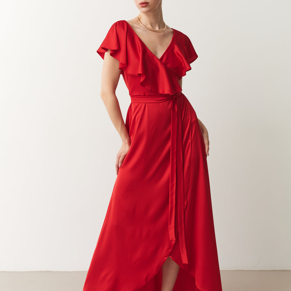 Woman wearing a red dress with ruffled top on a white background